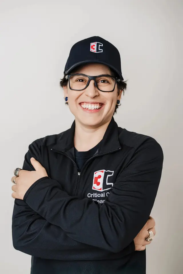 Alex Tonsberg, owner of Critical Care Cleaning, arms crossed in a navy cap and quarter-zip