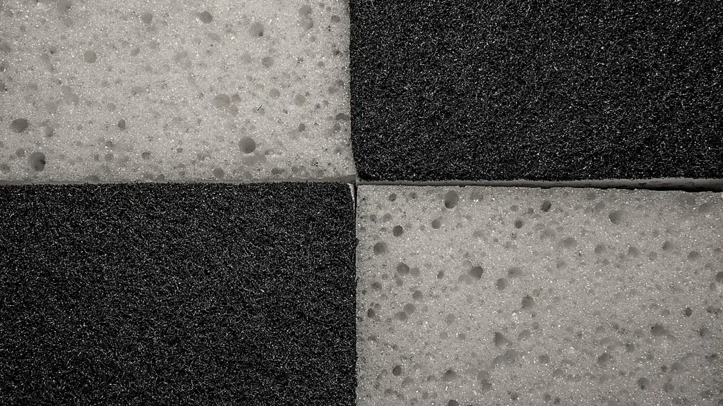 White sponge and black scour pad laid in a checker pattern